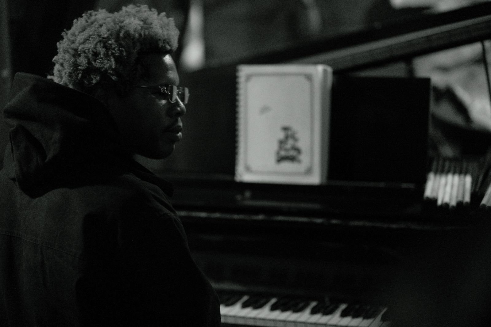 Pianist in profile at an upright piano