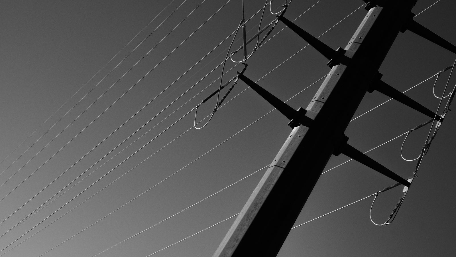 Electricity pylon and cables against a grey sky